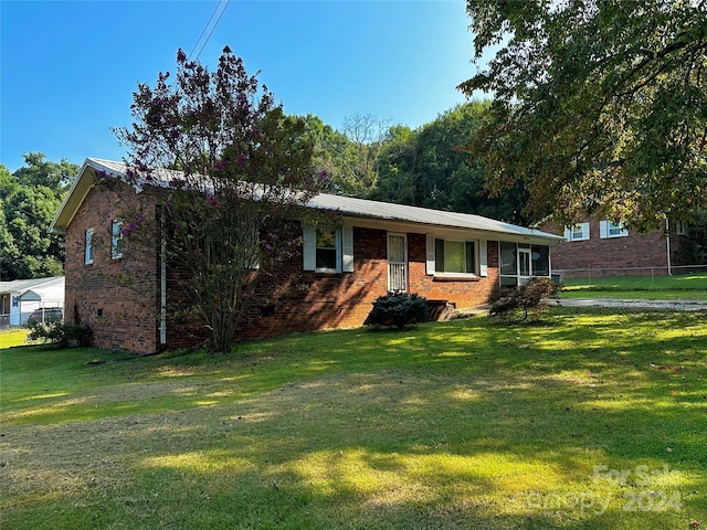 ranch-style home featuring brick siding, crawl space, a front yard, and fence