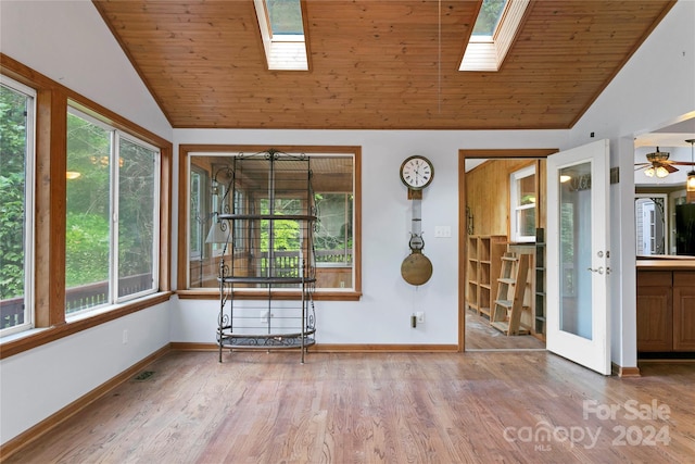 interior space featuring a wealth of natural light, wooden ceiling, and a skylight