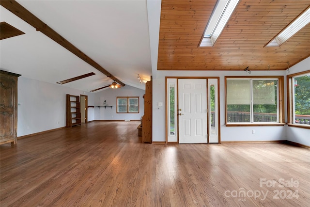 unfurnished living room featuring wooden ceiling, vaulted ceiling with skylight, wood-type flooring, and ceiling fan