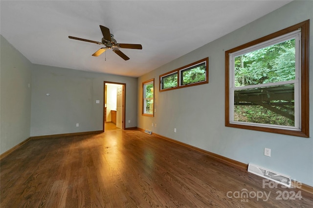 empty room featuring hardwood / wood-style floors, ceiling fan, and a healthy amount of sunlight