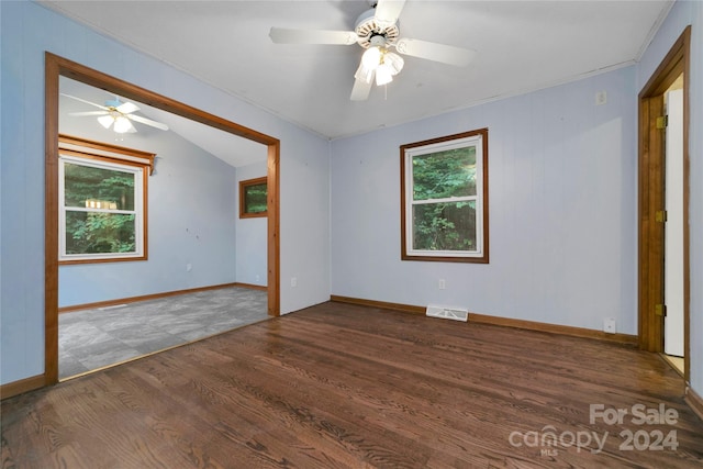 unfurnished room featuring ornamental molding, dark hardwood / wood-style flooring, ceiling fan, and lofted ceiling