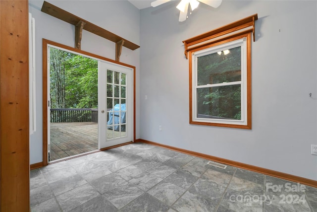 spare room featuring ceiling fan and french doors