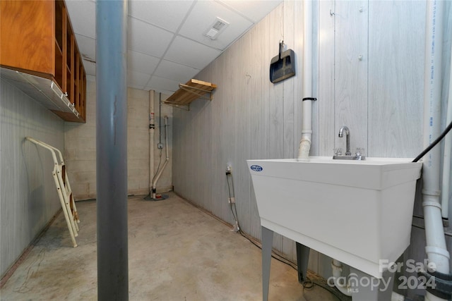 basement featuring a paneled ceiling