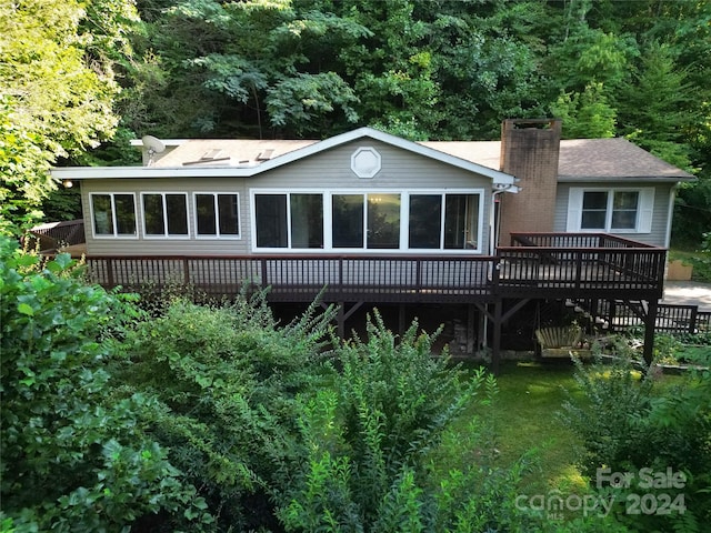 back of property featuring a wooden deck