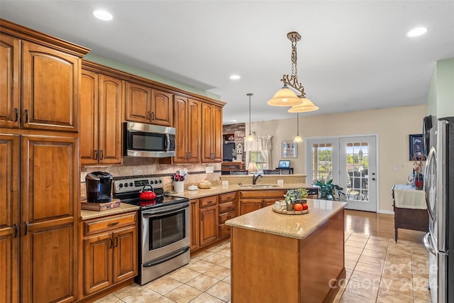 kitchen featuring pendant lighting, light tile patterned floors, tasteful backsplash, stainless steel appliances, and sink