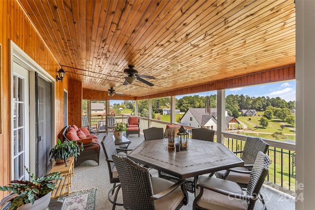 sunroom with wood ceiling and ceiling fan