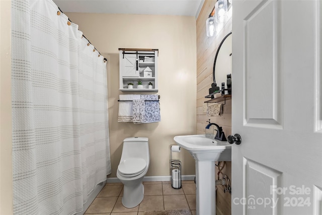 bathroom with toilet and tile patterned floors