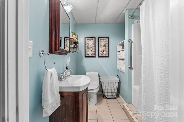 bathroom with tile patterned flooring, toilet, a textured ceiling, and vanity