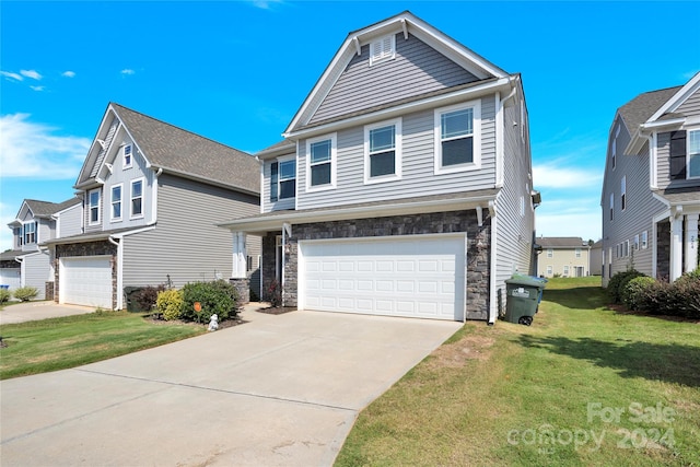 view of front of property with a garage and a front yard