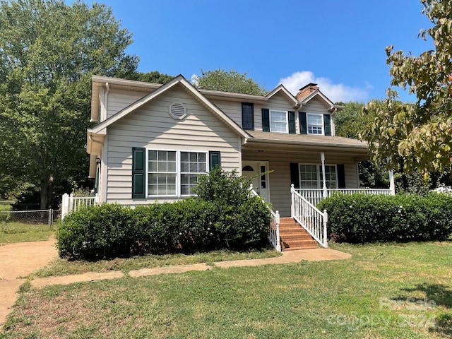 view of front of home featuring a front yard and a porch