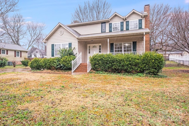 view of front of home featuring a front yard and covered porch