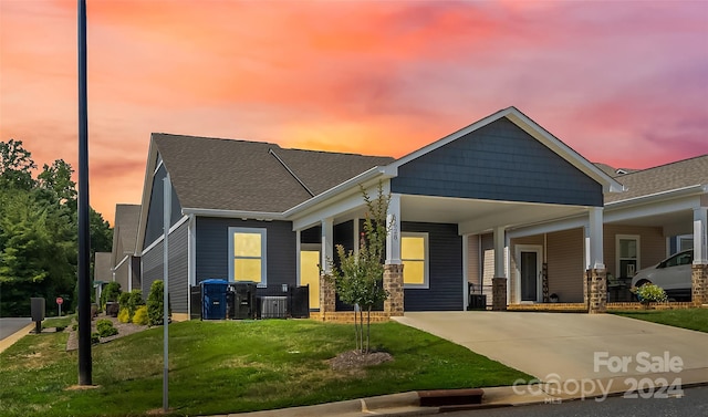 view of front of property with a porch and a lawn