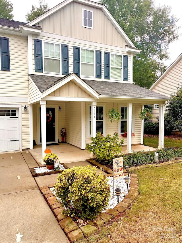 view of front facade featuring a porch and a garage