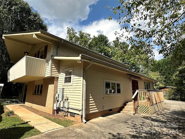 view of side of property with a balcony