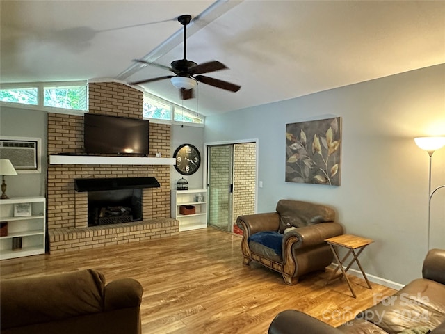 living room with lofted ceiling, ceiling fan, a wealth of natural light, and a brick fireplace