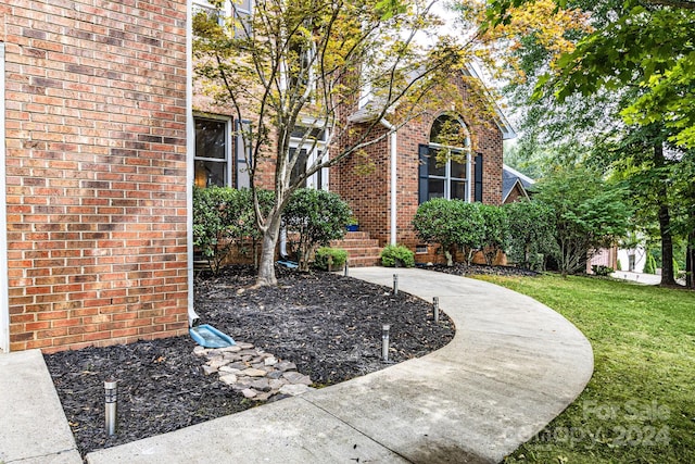 view of exterior entry featuring a yard