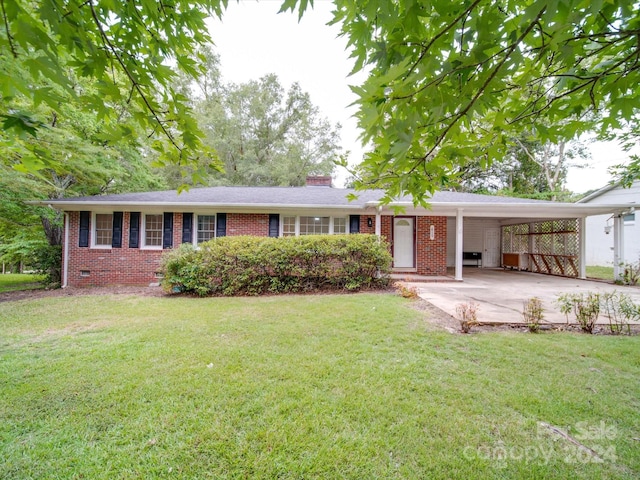 single story home featuring an attached carport, driveway, a chimney, a front lawn, and brick siding