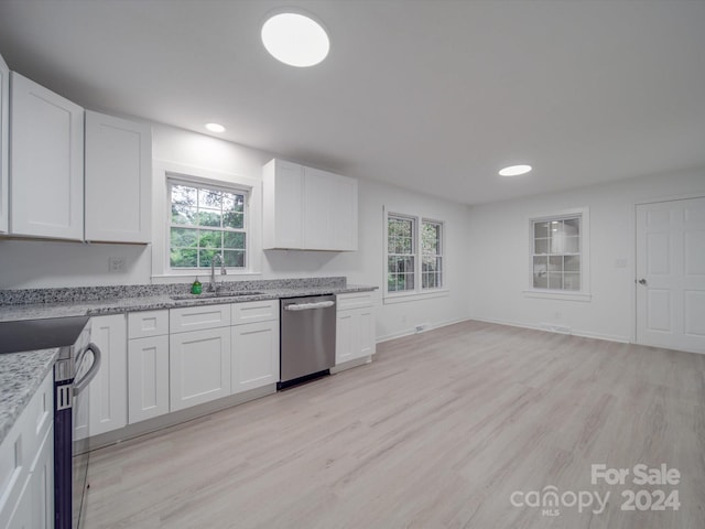 kitchen with white cabinetry, light hardwood / wood-style flooring, and stainless steel appliances