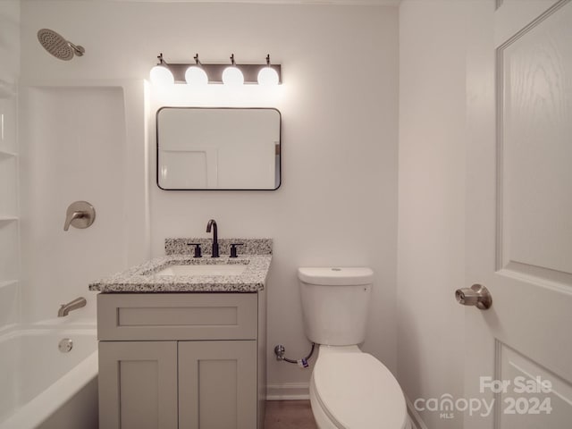 bathroom featuring toilet, vanity, and bathing tub / shower combination