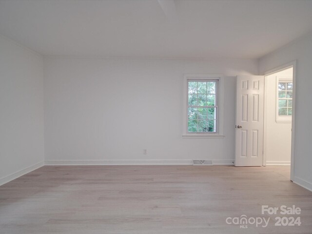 empty room with light hardwood / wood-style floors