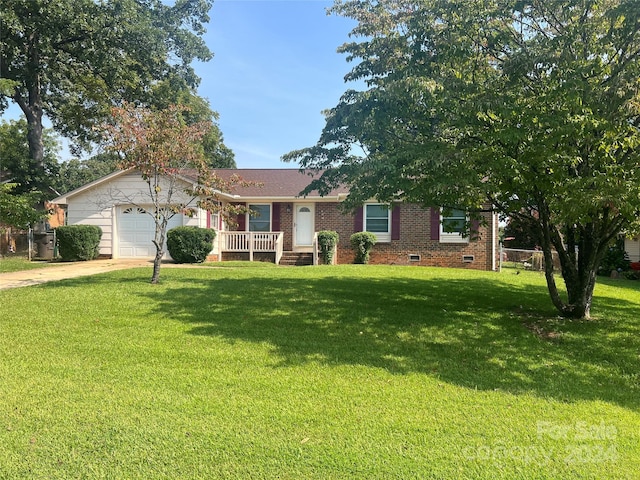 ranch-style house featuring a garage and a front lawn