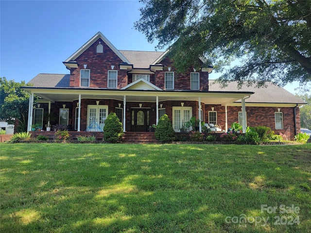 view of front of property with covered porch and a front lawn