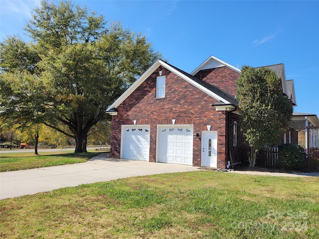 view of front of house with a front yard and a garage