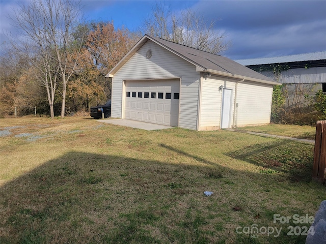 garage featuring a lawn