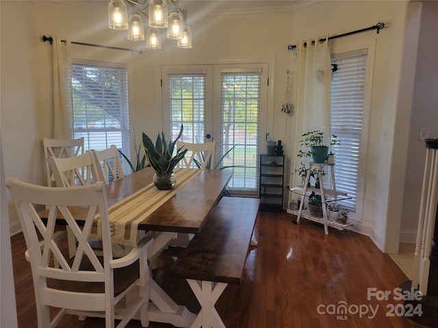 dining room featuring crown molding, a notable chandelier, and dark hardwood / wood-style flooring