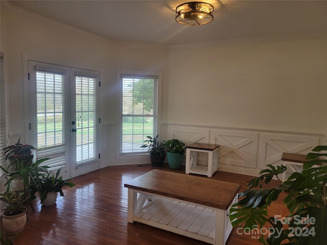 living area with ornamental molding and dark hardwood / wood-style flooring