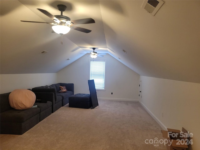 interior space featuring light carpet, vaulted ceiling, and ceiling fan