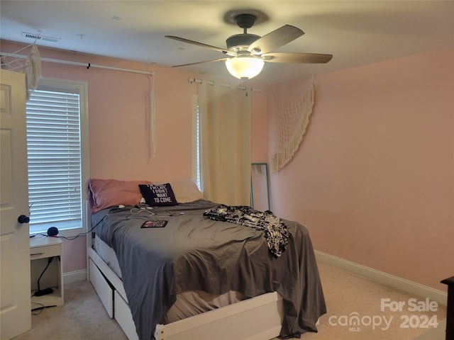 bedroom featuring ceiling fan and light carpet