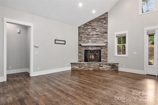 unfurnished living room with high vaulted ceiling, dark wood-type flooring, and a fireplace