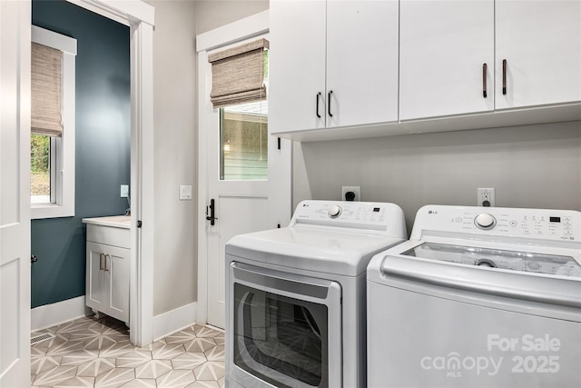 washroom with cabinets and separate washer and dryer