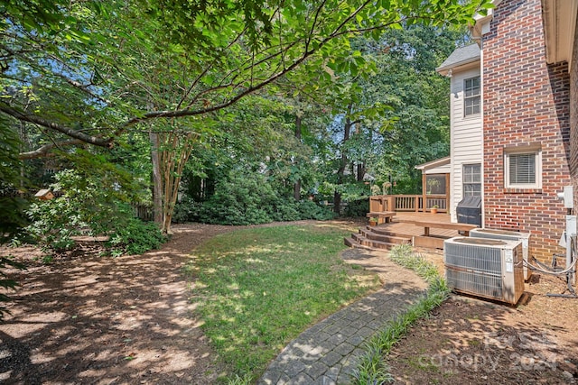 view of yard with cooling unit and a wooden deck