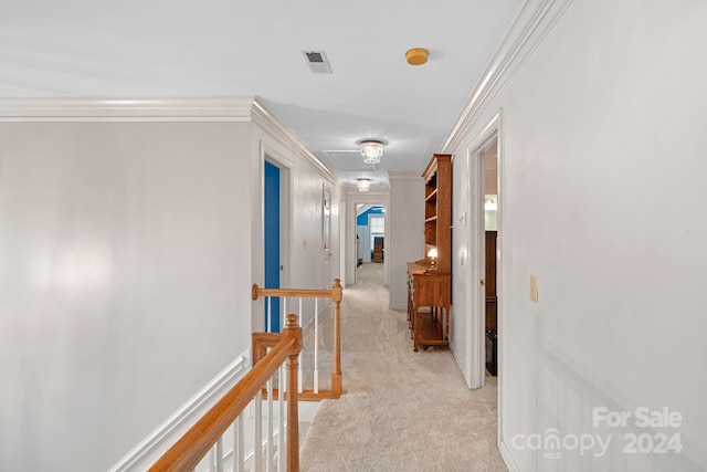 hall featuring ornamental molding and light colored carpet