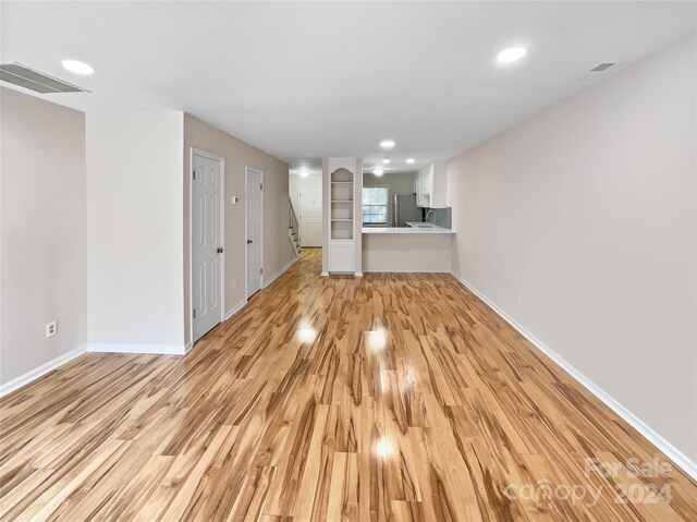 unfurnished living room with light wood-type flooring