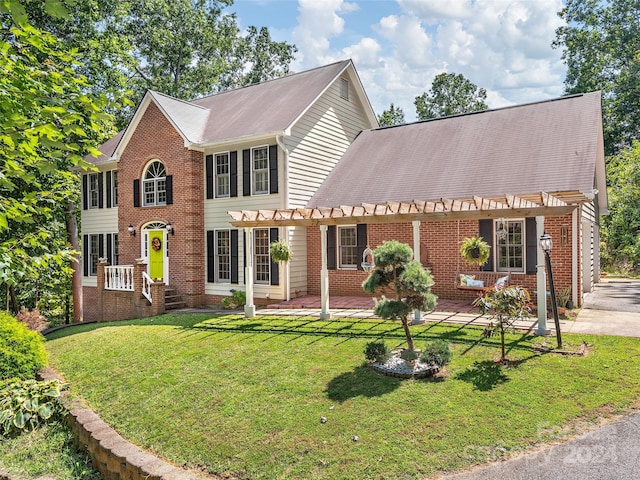 colonial home featuring a pergola and a front lawn