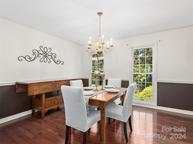 dining space with an inviting chandelier, dark hardwood / wood-style flooring, and crown molding