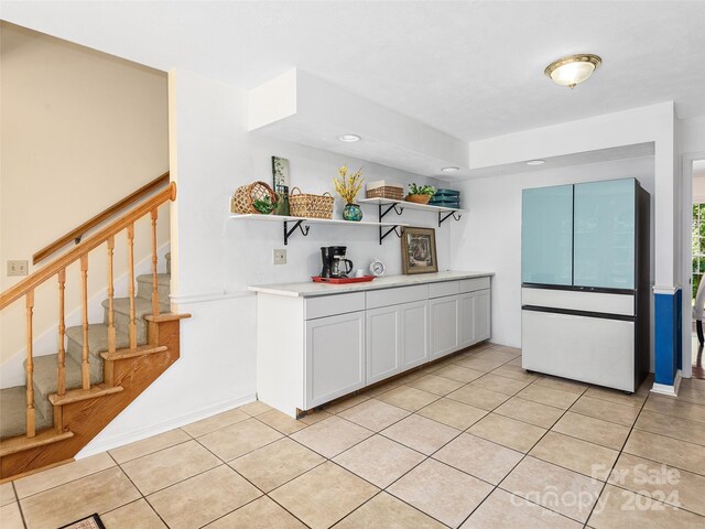 kitchen with white cabinets and light tile patterned flooring