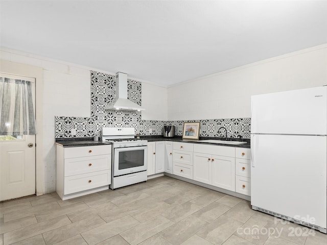 kitchen featuring white cabinets, white appliances, sink, wall chimney exhaust hood, and decorative backsplash