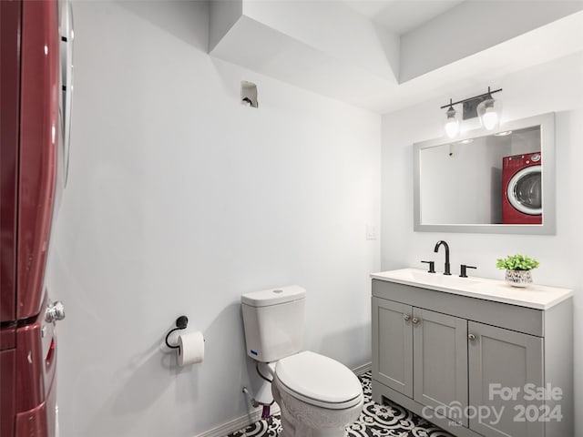 bathroom with tile patterned flooring, vanity, and toilet