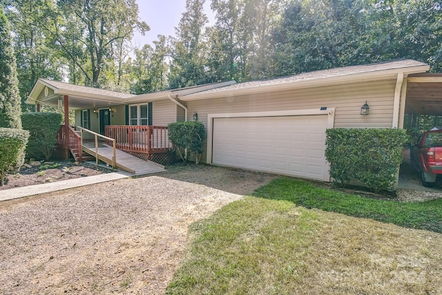 ranch-style home featuring a garage, a carport, and a front yard