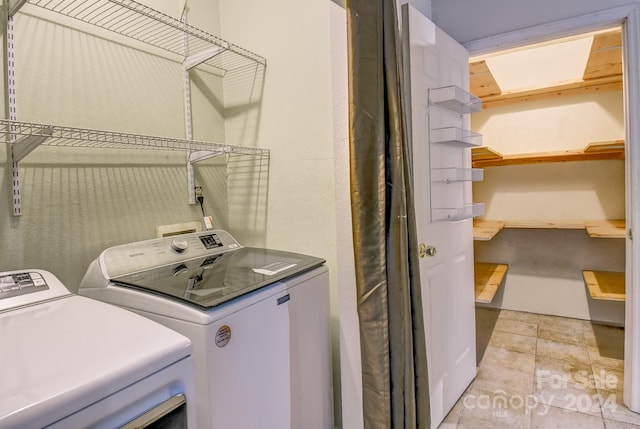 clothes washing area with separate washer and dryer