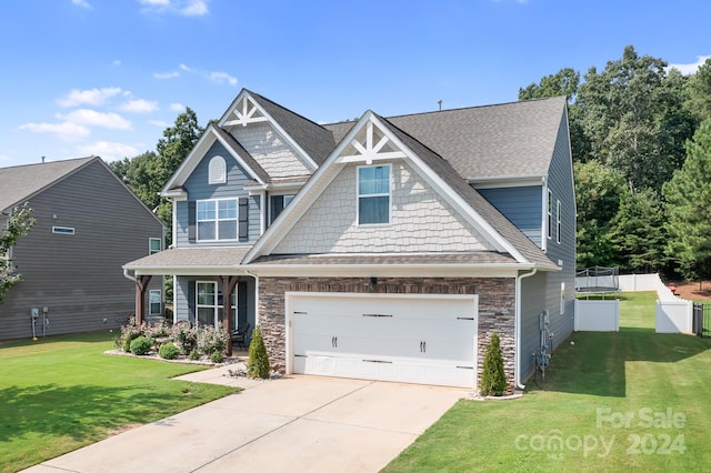 craftsman inspired home with a front yard and a garage