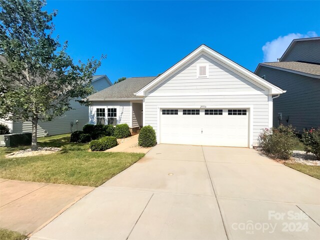 view of front of property featuring a garage and a front yard