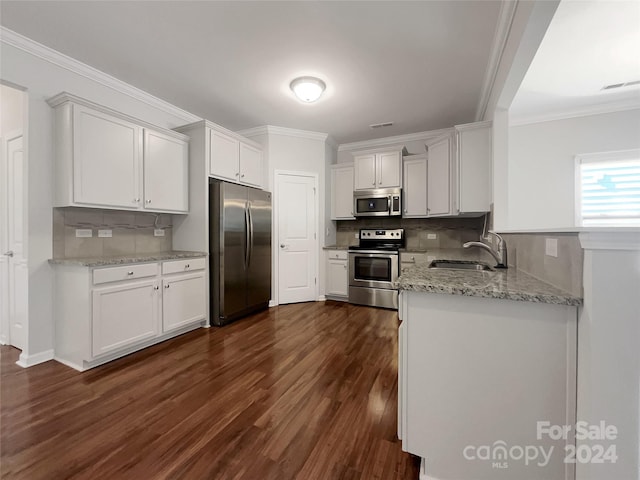 kitchen featuring appliances with stainless steel finishes, dark wood finished floors, visible vents, and crown molding