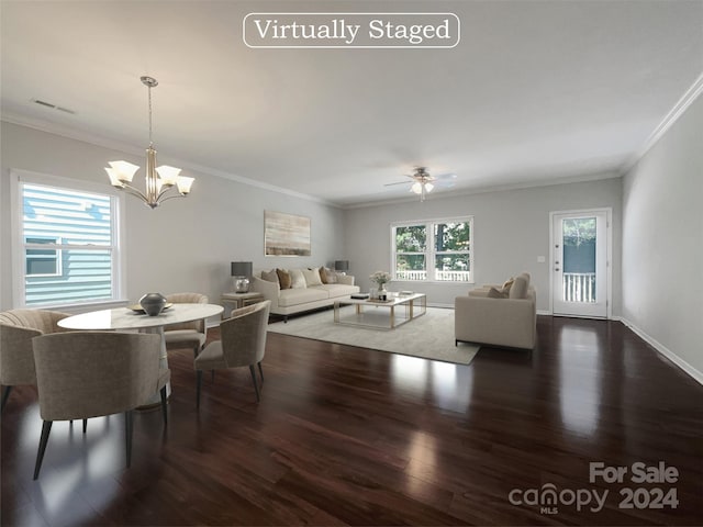 dining area with visible vents, ornamental molding, wood finished floors, baseboards, and ceiling fan with notable chandelier