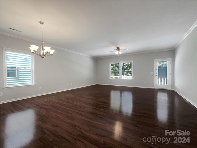 empty room with crown molding, dark hardwood / wood-style floors, and ceiling fan with notable chandelier