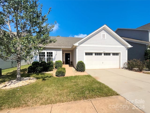 single story home featuring a garage, concrete driveway, a front lawn, and a shingled roof